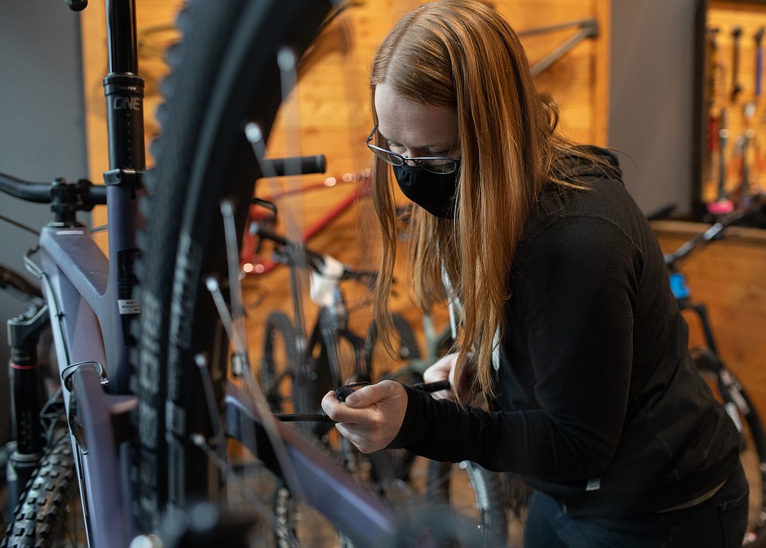 Emma Heller tunes a bike at Transition Bike Company and Outpost in December 2021. Transition opened the outpost in July 2021 near a Galbraith trailhead.