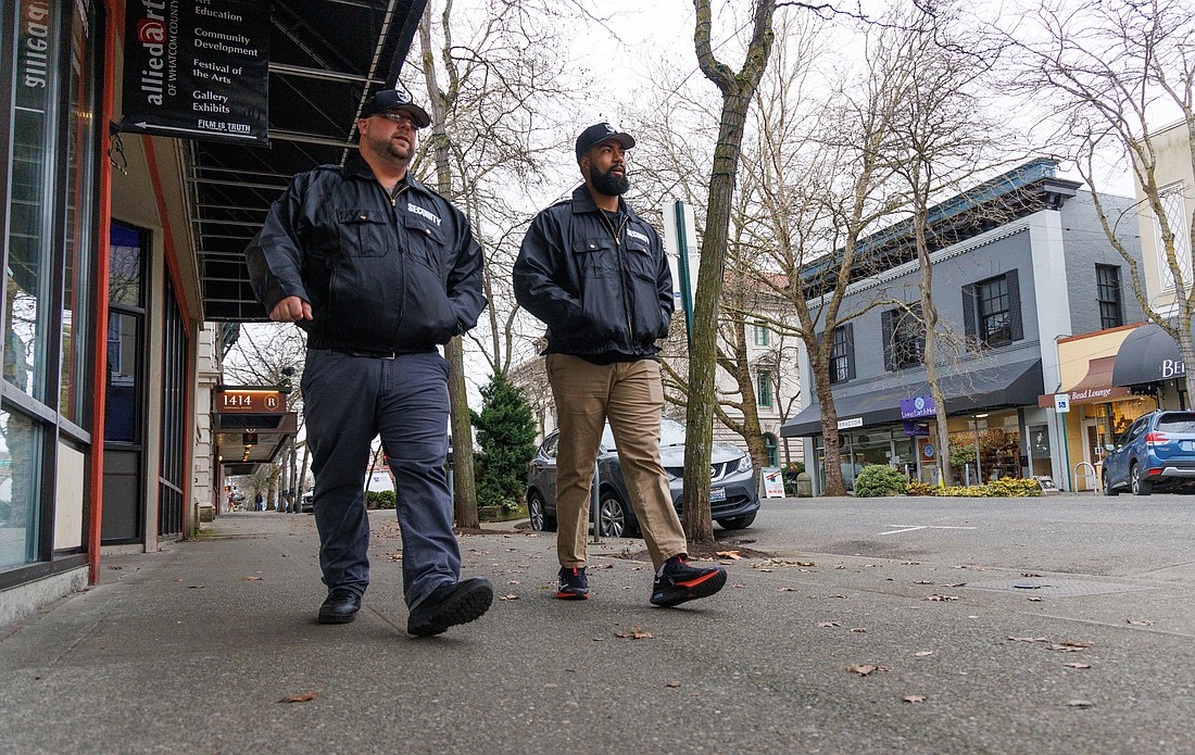 Chris Nelson, left, and Caleb Rodriguez from Risk Solutions Unlimited patrol downtown Bellingham on Feb. 2. Bellingham contracted with the security company to provide 24/7 service through April.