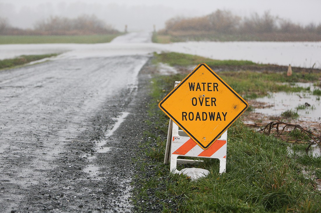 Water runs over a road in Lynden on Nov. 14, 2021. A bill sponsored by Alicia Rule and Simon Sefzik would provide relief to farmers who lost income due to the Nooksack River floods.