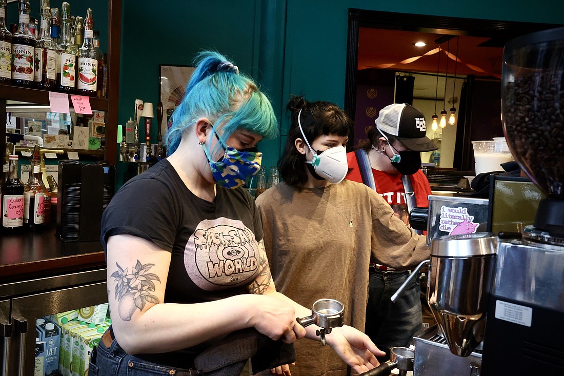 Black Drop employees Sarah Homeyer, left, Taylor Lukens, middle, and Liso Elliott, right, brew drinks for customers on Feb. 3.