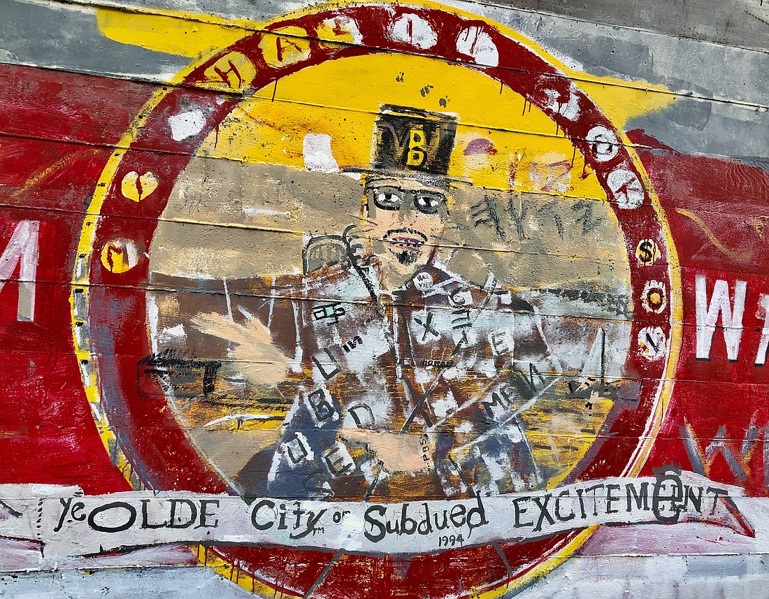 Stephen Stimson, who owned Lone Wolf Antiques on 109 Prospect St., painted a mural welcoming people to Bellingham in 1995 on his building. Stimson decided to paint “Ye Olde City of Subdued Excitement” because the “s” words flowed well with the “c” in city. Though not an official motto for Bellingham, the slogan stuck.