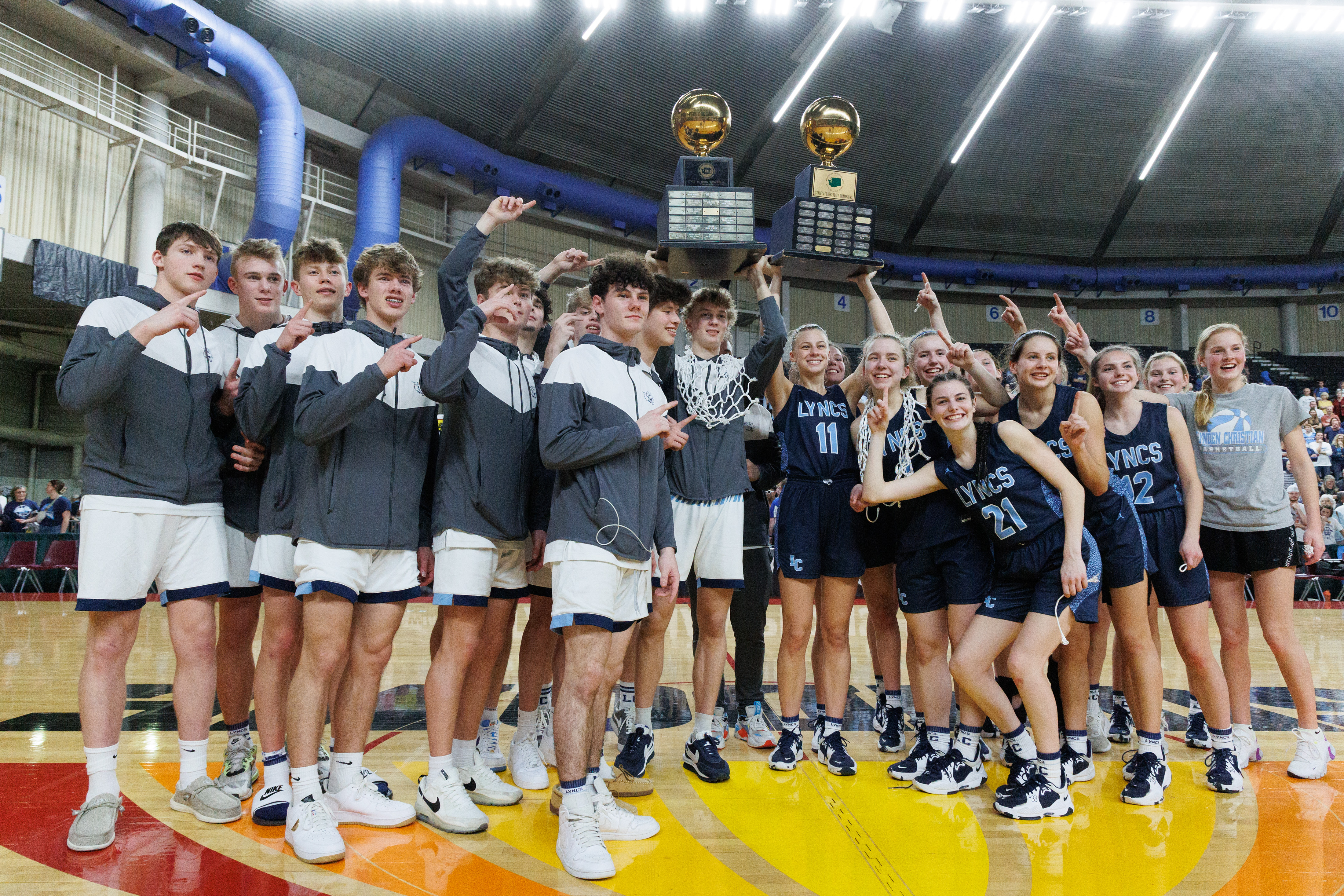 The Lynden Christian boys and girls teams celebrate as both won their respective 1A state championship titles at the Yakima Valley SunDome on March 5.