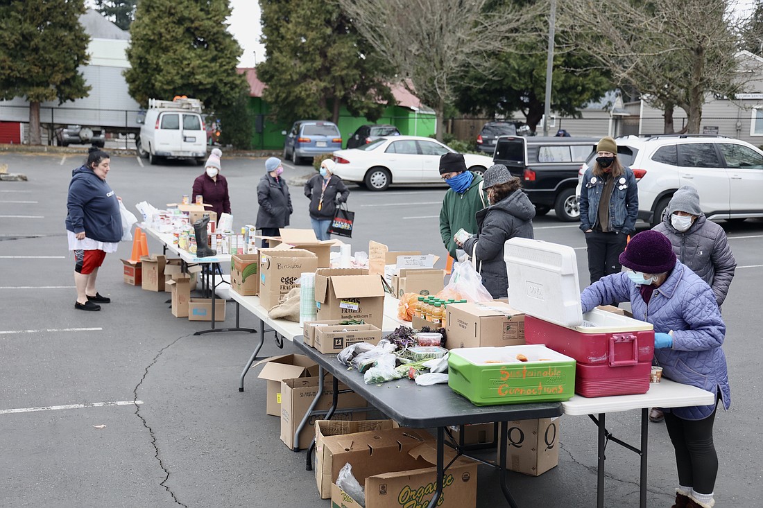 Volunteers arrange donations at the Saturday Share Spot on Feb. 26.
