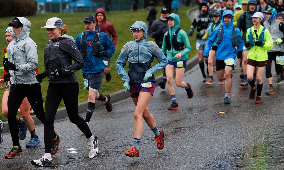 Runners bundle up as the rain pours down at the start of the Chuckanut 50K race in Fairhaven Park on March 19.