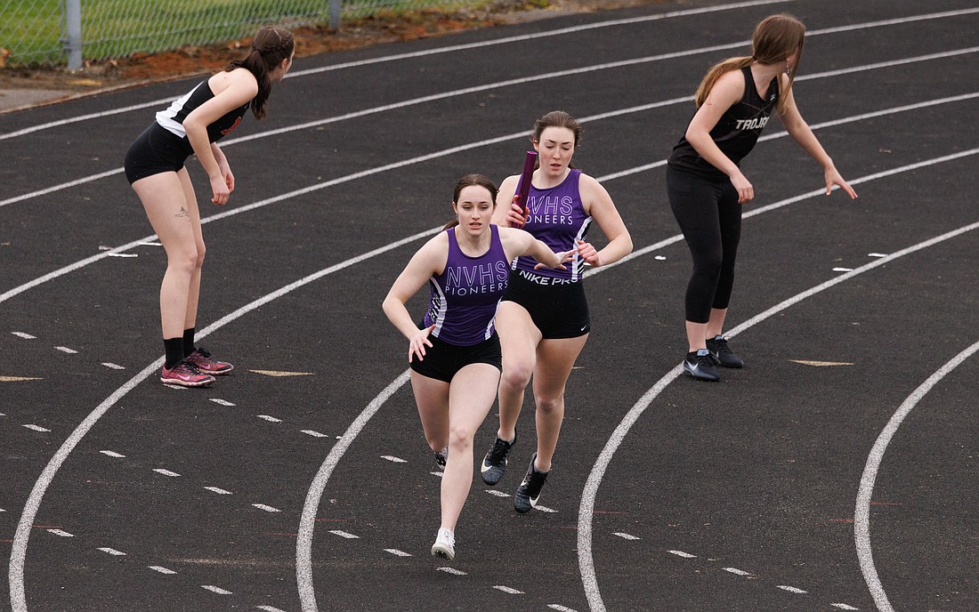 With a commanding lead, Nooksack Valley runners hand off the baton for the final leg of the 4x100 meter relay during a track meet at Meridian High School on April 1.