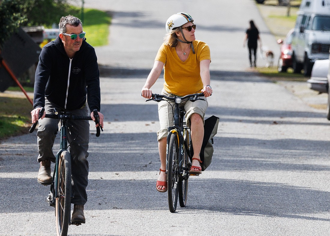 Bikers and walkers enjoy the slow pace of Donovan Avenue in Fairhaven on April 7. Neighbors worry an 80-foot sidewalk to be built at 801 Donovan will disrupt the neighborhood's character.