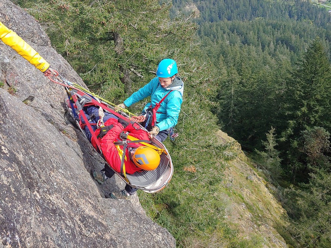 A rescuer practices a lower with a litter during an American Alpine Institute rescue program.