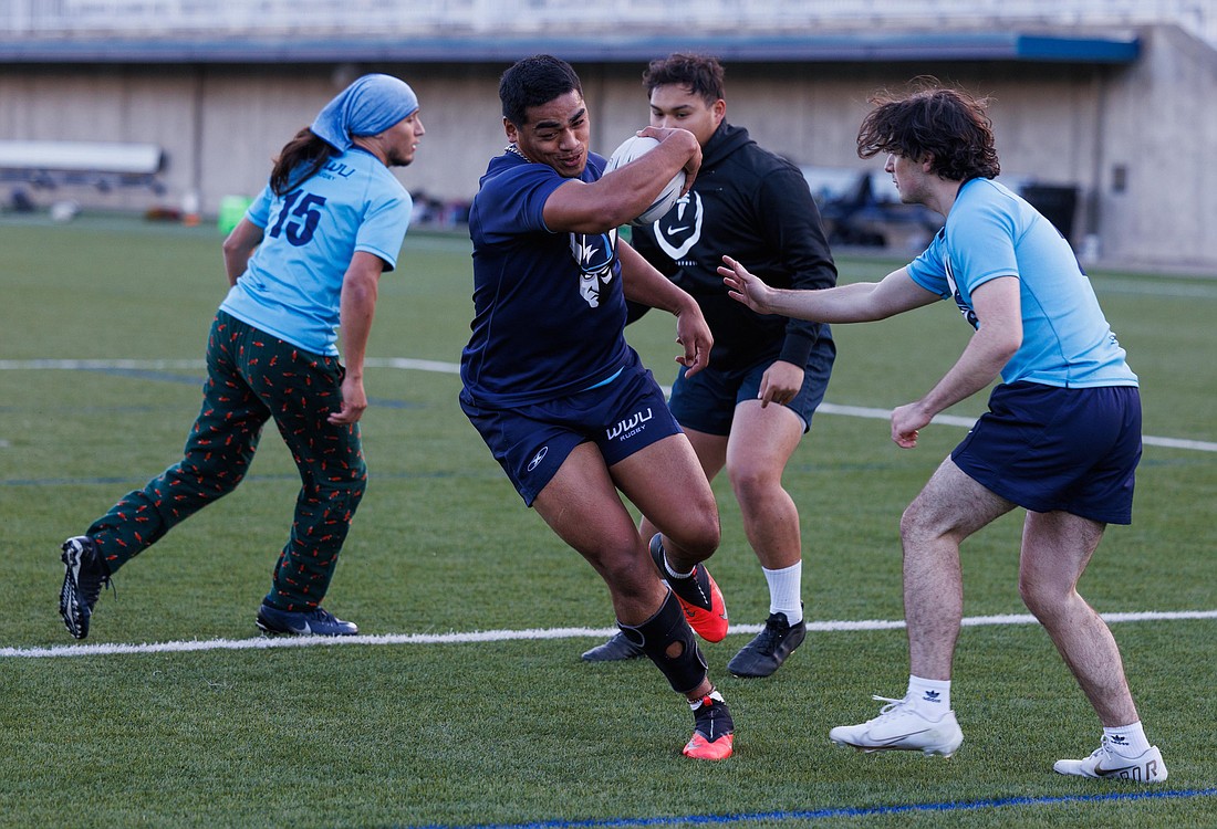 Desmond Maiava breaks through on a play as the Western Washington University rugby team practices at Harrington Field on April 11.