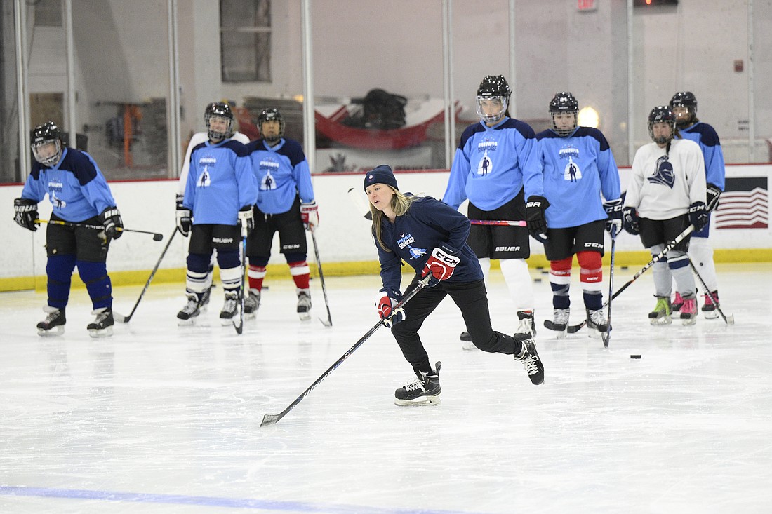 United States hockey player Haley Skarupa, front, demonstrates a drill during a hockey clinic presented by the Washington Capitals and the Professional Women's Hockey Players Association, Friday, March 4, 2022, in Arlington, Va. The Professional Women’s Hockey Players Association has decided to break off talks with the rival Premier Hockey Federation, the latest blow in a widening rift between two factions that contend they want to grow the sport in North America.