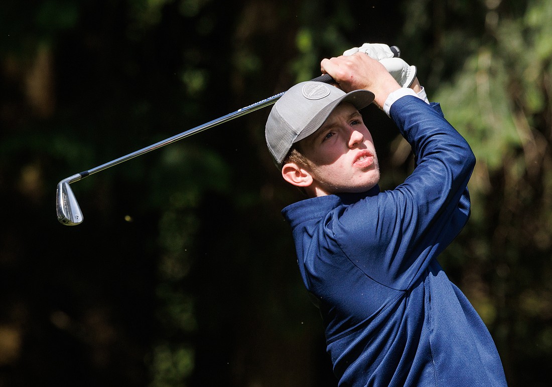 Using an iron, Ferndale’s Baylor Larrabee tees off during a boys golf match on April 21 at Lake Padden Golf Course.