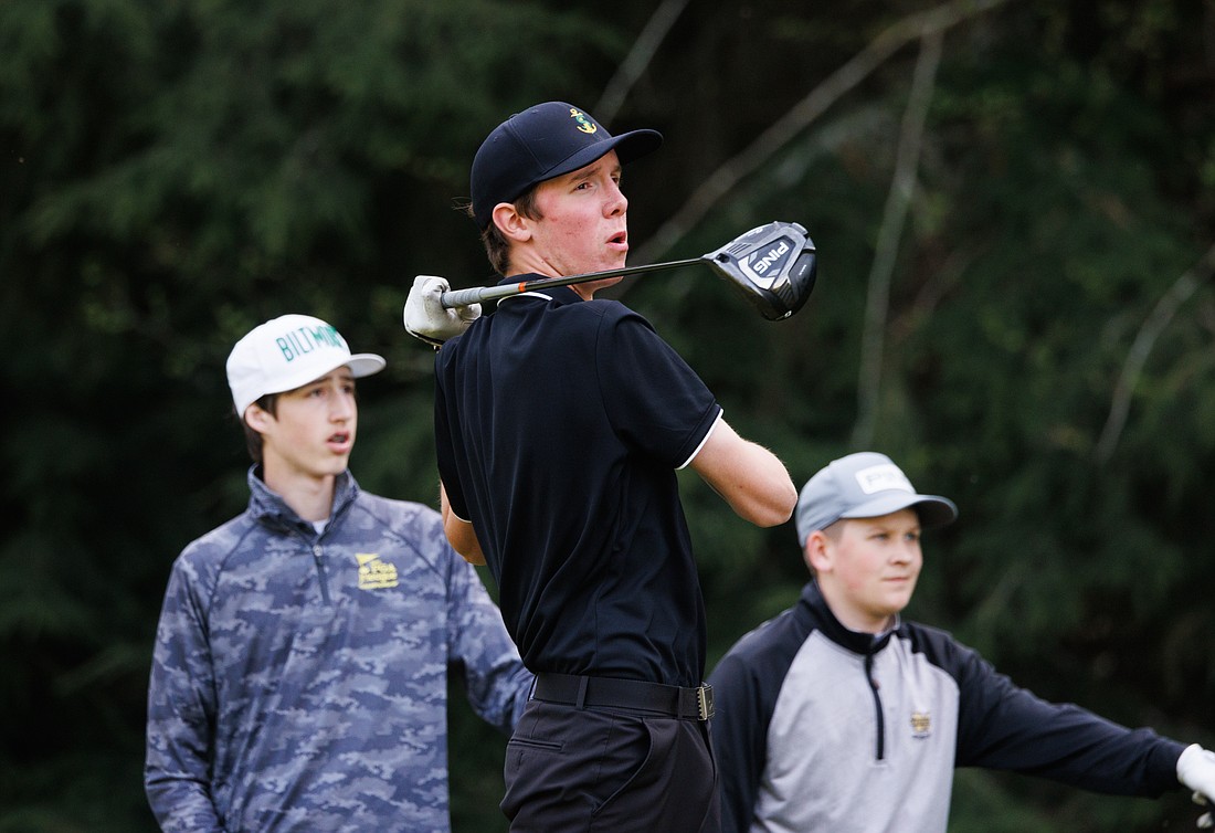 Sehome’s John Kummer, center, reacts as he hits an errant tee shot during a boys golf match on April 21 at Lake Padden Golf Course.