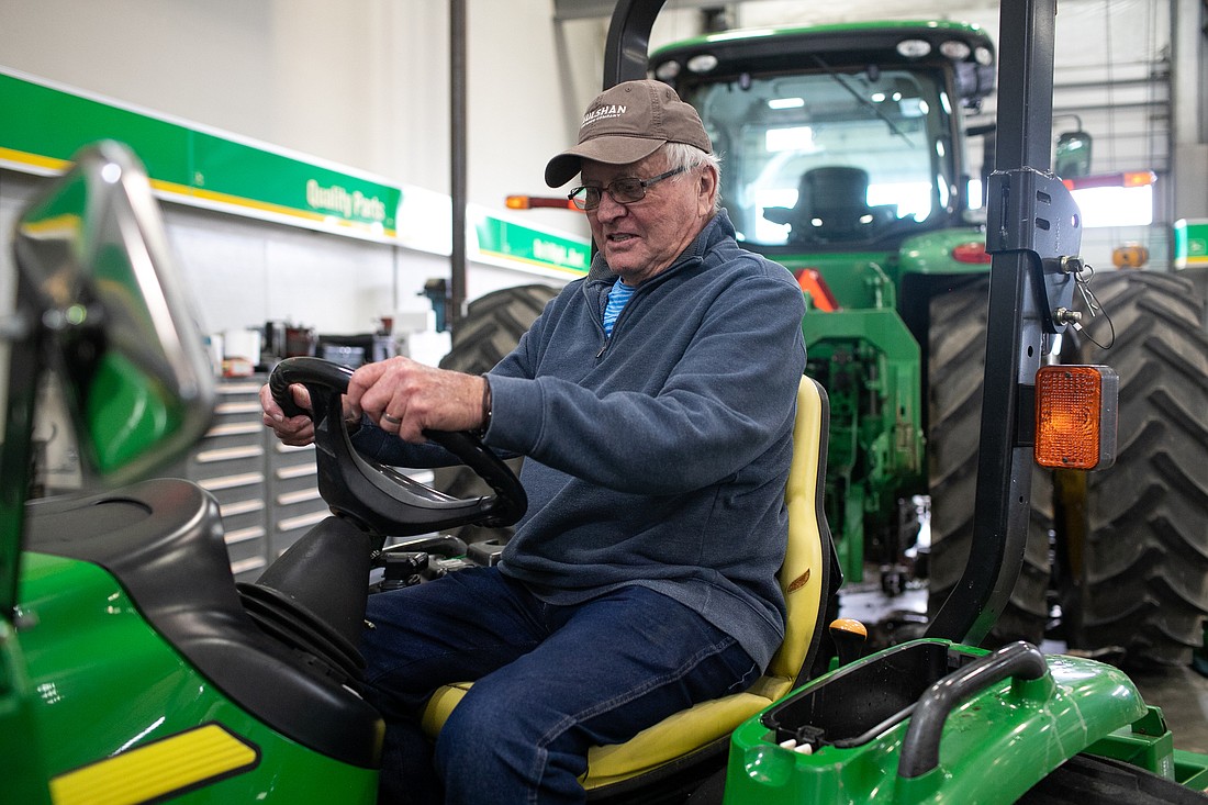 Mike Adkinson sits on the John Deere tractor he will drive across the country starting this month. Adkinson will use the trip to raise awareness for Parkinson's disease and raise money for the American Parkinson Disease Association Northwest Chapter.