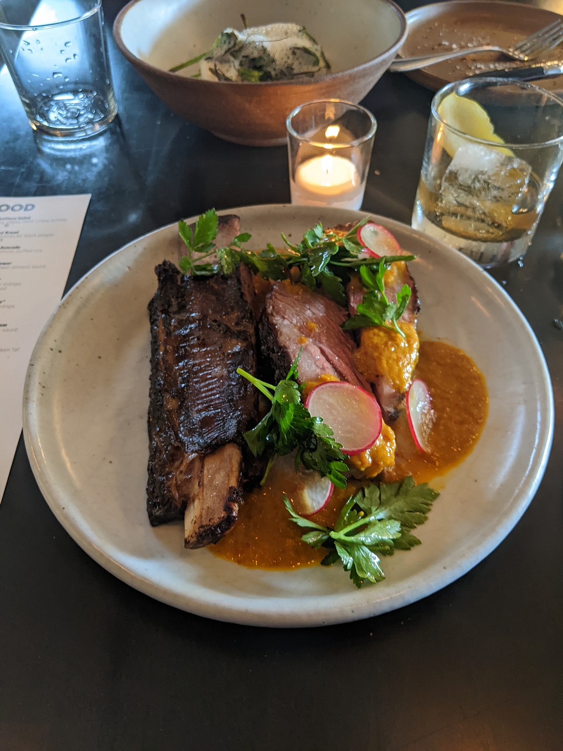 Carnal's slow-cooked, bone-in, beef short rib arrives with the bulk of the meat already sliced away from the bone. Fire roasted and drizzled in a turmeric and mango puree, it takes a lot of willpower to not grab it and gnaw on it like a caveman squatting over a campfire.