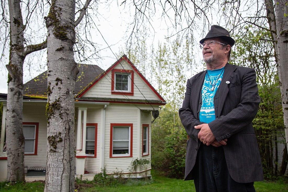 Andy Koch stands outside of his former home on 21st Street in Bellingham. He rented the home for several decades until his landlord died suddenly in 2018. Koch re-entered an unfamiliar world of rentals, where prices had soared far above what he was paying in rent for his Happy Valley home.