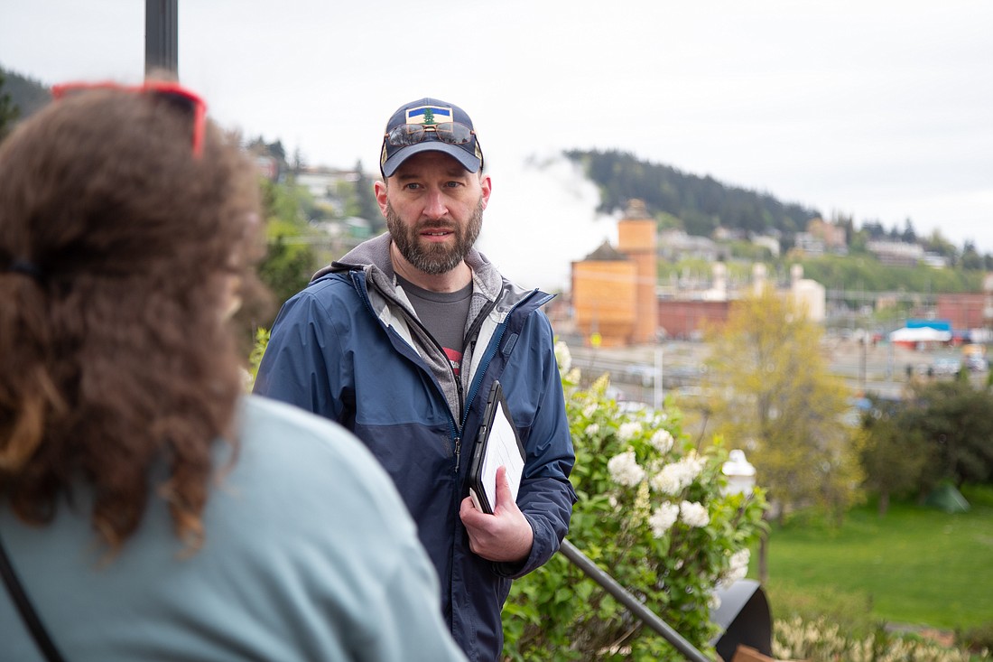 Ian Stacy talks with students about the waterfront from the top of the stairs at Maritime Heritage Park on May 3.