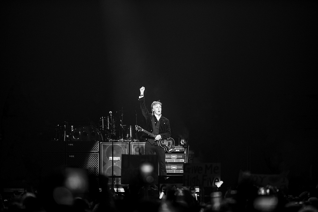 Sir Paul McCartney holds up a fist after playing the first song of the night at his May 2 show at Seattle’s Climate Pledge Arena. McCartney opened the show with The Beatles’ “Can’t Buy Me Love.”