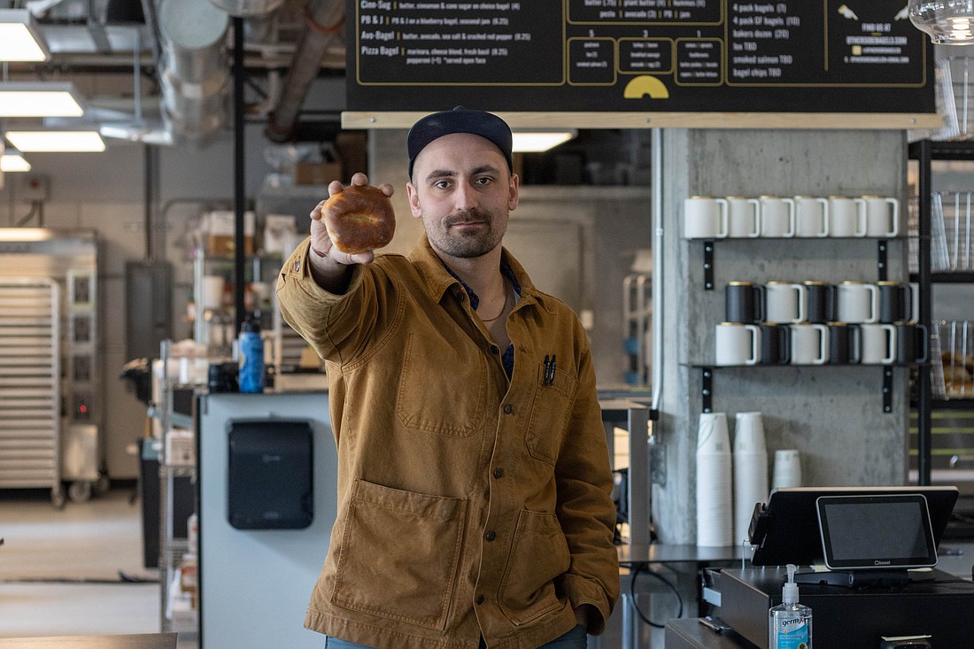 Bayly Peterson, Otherside Bagel Co. owner, holds up a plain bagel prior to the shop's grand opening, taking place Friday, May 13. Peterson, who also owns AB Crepes, is starting the second bagel shop in Whatcom County with business partner Nate Gray.