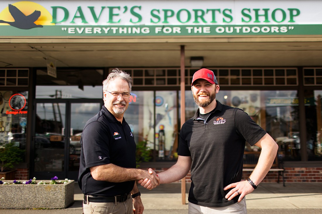 Dave VanderHoek and Will Lathrop shake hands outside Dave's Sports Shop, located on 1738 Front St. in Lynden