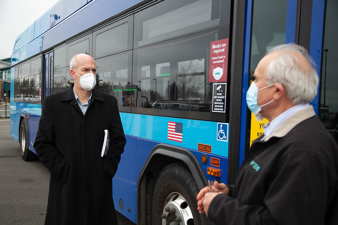U.S. Rep. Rick Larsen, left, speaks in January with Mike Bozzo, Whatcom Transportation Authority's fleet and facilities director, next to an electric-powered WTA bus at the agency's Bellingham headquarters. Larsen recently sent WTA a letter questioning its decision to acquire eight diesel buses in 2023.