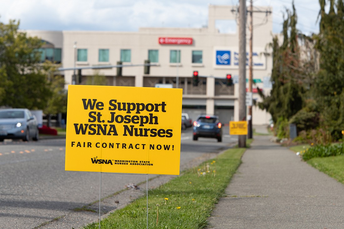 Signs of support for the nurses who work at PeaceHealth St. Joseph Medical Center line Ellis Street last month, near the hospital's entrance. Nurses and the hospital agreed to a new three-year contract on May 10.