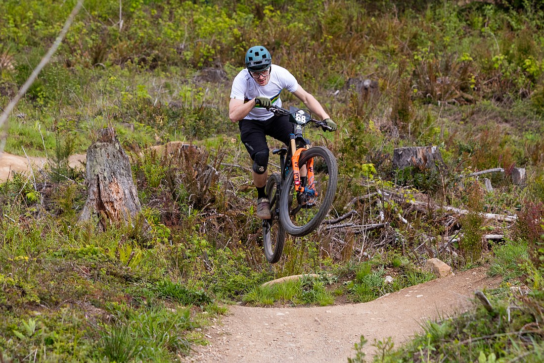 Eric Olsen, a member of the Fanatik Enduro team, jumps in the air next to the apres zone on the SST race course at Galbraith Mountain during the Whatcom World Cup opening night on May 14. Olsen took second place in the race and John Richardson took first. Olsen said in an Instagram post both he and Richardson broke the previous fastest winning record on SST since 2019.