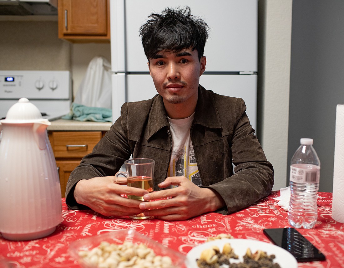 Essa Masih sits at his dining room table in the apartment where he lived in Bellingham for several months. He and his family settled in Bellingham after fleeing Afghanistan last August. He moved down to Seattle last week.