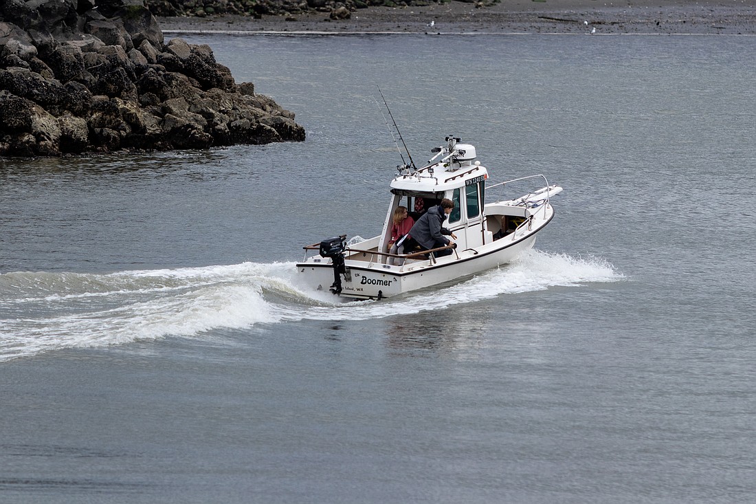 The fishing motorboat, OK Boomer, takes off from Squalicum Harbor into Bellingham Bay on May 17.