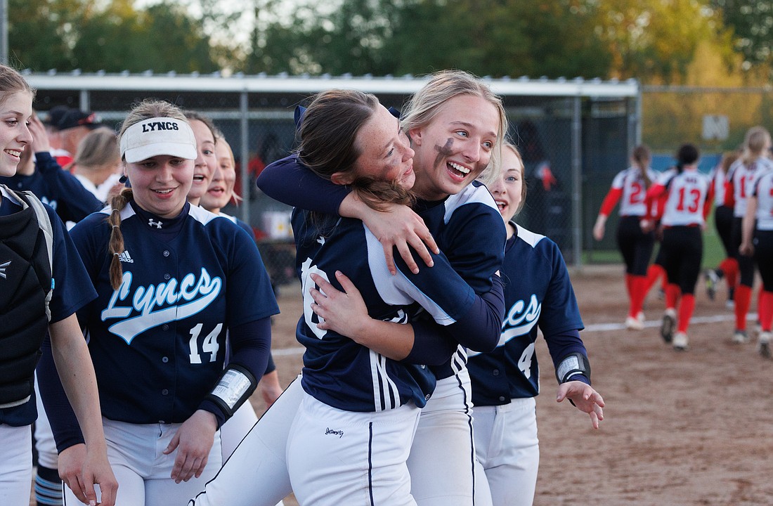 Lynden Christian's Libby Bouwman and Katie Korthuis hug after beating Mount Baker 12-7 at Janicki Fields on May 19 in Sedro-Woolley.