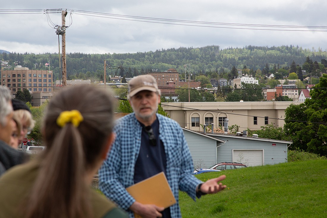 Lettered Streets residents including Geoff Vogel, right, discuss Lighthouse Mission Ministries' plans for a new homeless shelter at the site of its current Mission center, visible in the background on May 27. Project proponents and critics will have a chance to comment on the proposal before the Bellingham hearing examiner.