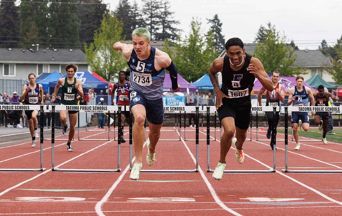 Squalicum’s Andre Korbmacher edges Foster's Lyricc Lopez to win the 300-meter hurdles during the 2A state track championships on May 28 in Tacoma.