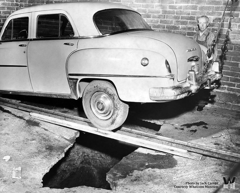 In 1954, Henry Flockenhagen's car fell into a 12-foot hole in a garage behind the Sanitary Meat Co. on 1017 State St. It's likely this hole emerged due to a cave-in of a Sehome mine shaft.