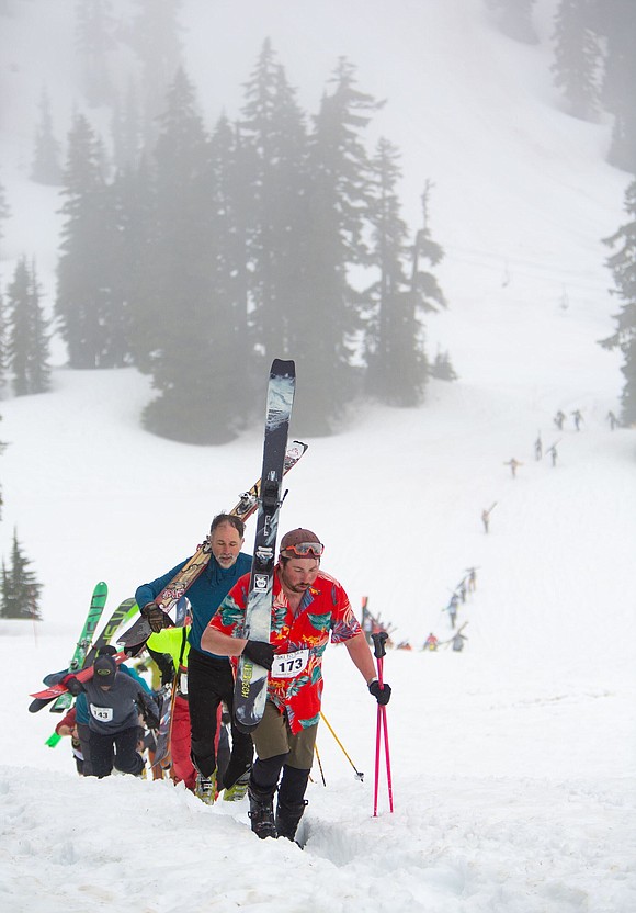 Brandon Lee from Team Jake and dozens of others make the more than 800-feet elevation climb up the mountain to ski down.