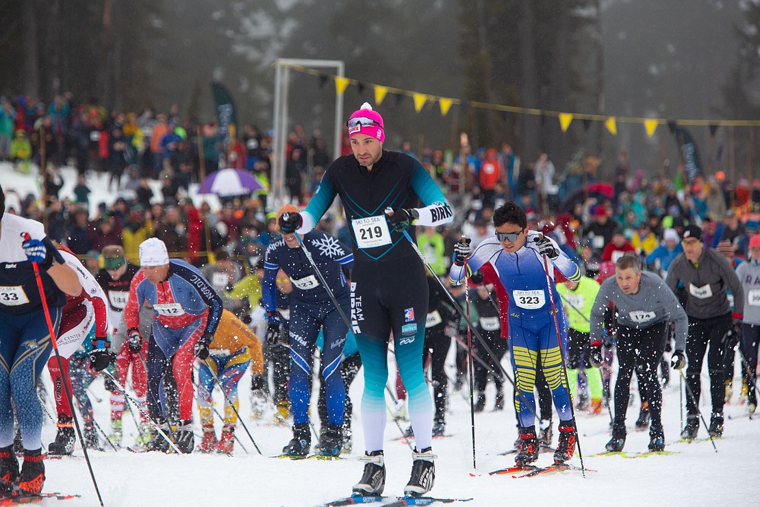 Chris Queitzsch of IndustrialCU (219) shoots off from the starting line of the 2022 Ski to Sea race, which begins with a cross-country leg. Racers hand off the baton to "downhill" skiers next, then runners pound pavement down the mountain.