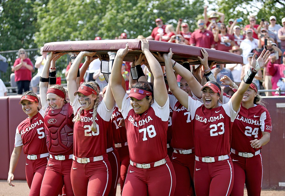 Oklahoma celebrates following an NCAA college softball super regional game against Central Florida in Norman, Okla., Saturday, May, 28.