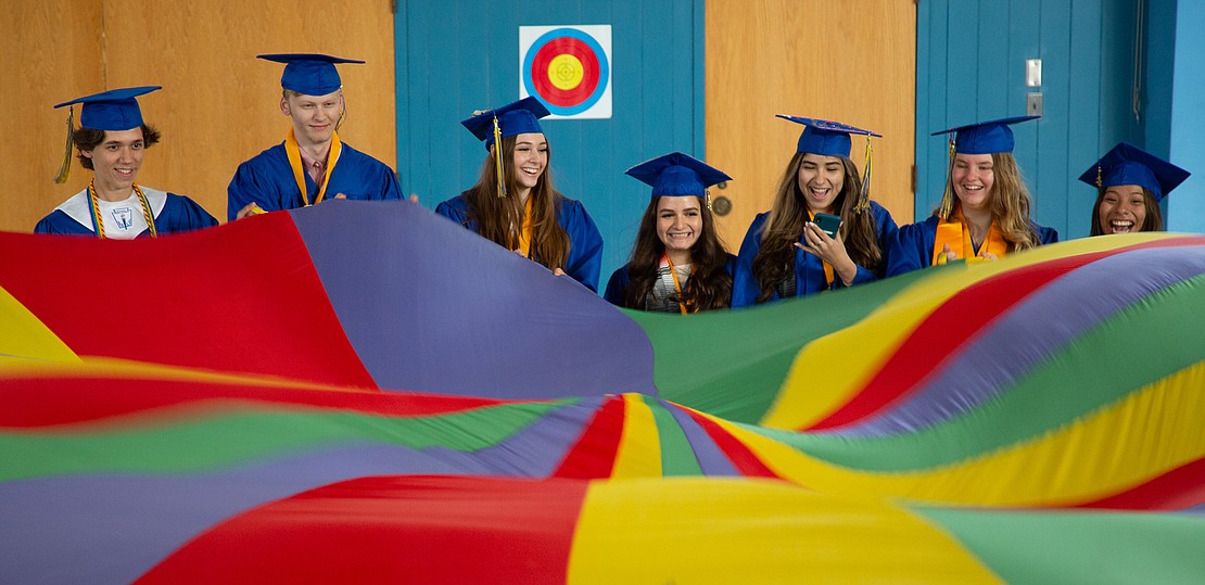 Ferndale High School graduates ripple the colorful parachute – everyone's favorite elementary gym class activity – in their old gym at Central Elementary School on June 10. The graduates walked the halls of their old school to cheers from former teachers and young students.