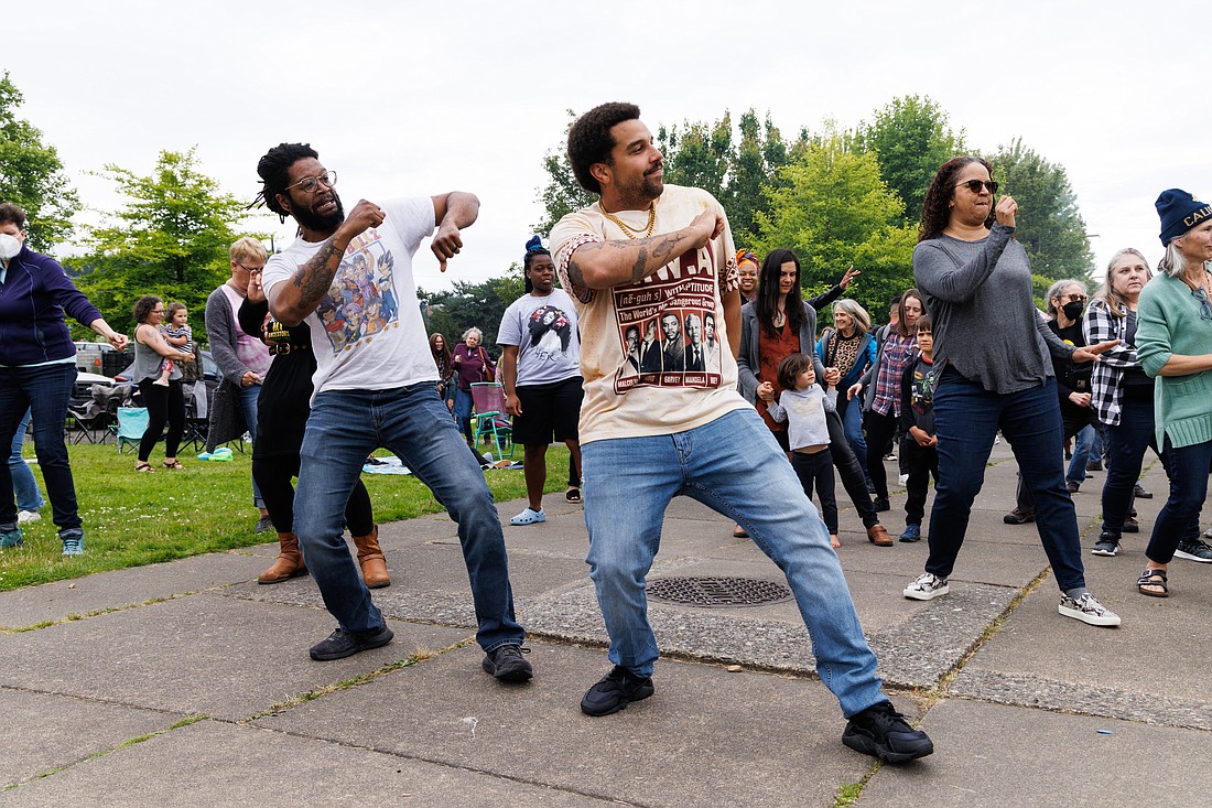 Jon James, left, and Trey Baker lead a dance at the Juneteenth Celebration at Maritime Heritage Park on June 18.