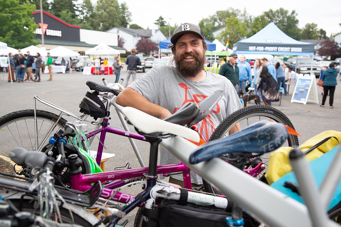 Alec Howard runs Go By Bike, his newly-launched bike valet service, at the Birchwood International Market on June 17.