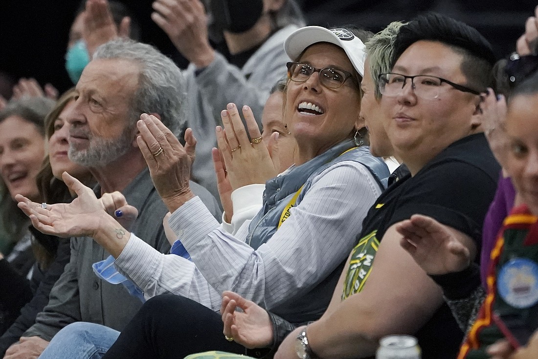 Seattle Storm co-owner Ginny Gilder, center, cheers as she sits courtside on May 18, 2022, at Climate Pledge Arena during a WNBA basketball game between the Seattle Storm and the Chicago Sky in Seattle. As Title IX marks its 50th anniversary in 2022, Gilder is one of countless women who benefited from the enactment and execution of the law and translated those opportunities into becoming leaders in their professional careers.