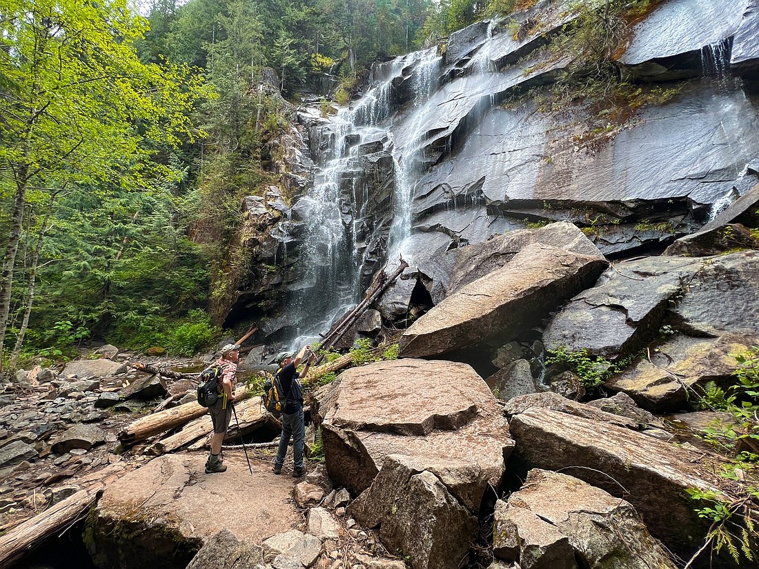 CDN outdoors columnist Elliott Almond, right, and fellow hiker Sandy McIntire marvel at a lower section of Bridal Veil Falls along the Lake Serene Trail on June 1 in the Mount Baker-Snoqualmie National Forest.