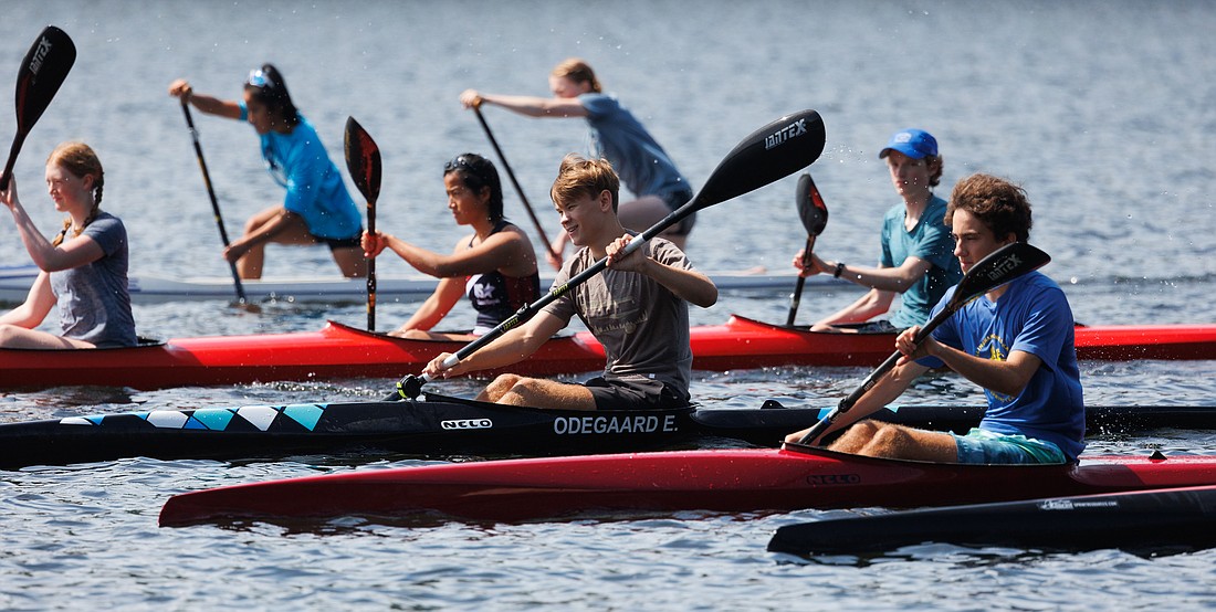 Singles and team rowers on the Bellingham Canoe and Kayak Sprint Team head back to the starting line while practicing sprint races on Lake Padden on Saturday.
