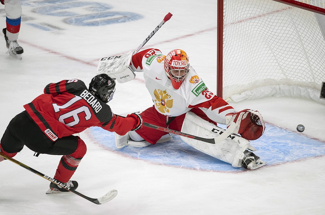 Canada's Connor Bedard (16) scores on Russia goalie Yegor Guskov (29) during the third period of an exhibition hockey game in Edmonton, Alberta, Dec. 23, 2021, before the IIHF World Junior Hockey Championship tournament. Yegor Guskov is one of several Russian goaltenders eligible to be taken in the 2022 NHL draft.