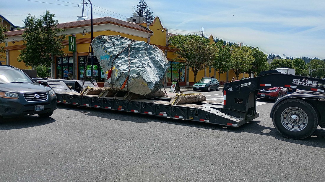 A tractor-trailer hauls a large basalt boulder through downtown Bellingham in June. This unusual cargo has been a regular sight on city streets over the past several months.