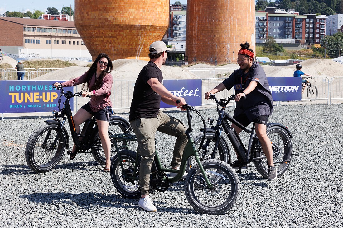 Riders chat about different e-bikes they tested during the Northwest Tune-Up on July 9.