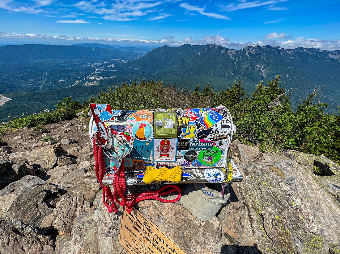The famed mailbox is the prime attraction on an 11.4-mile hike.  Seattle postal carrier Carl Heine lugged the original mailbox to the top in 1960 as a makeshift registry.