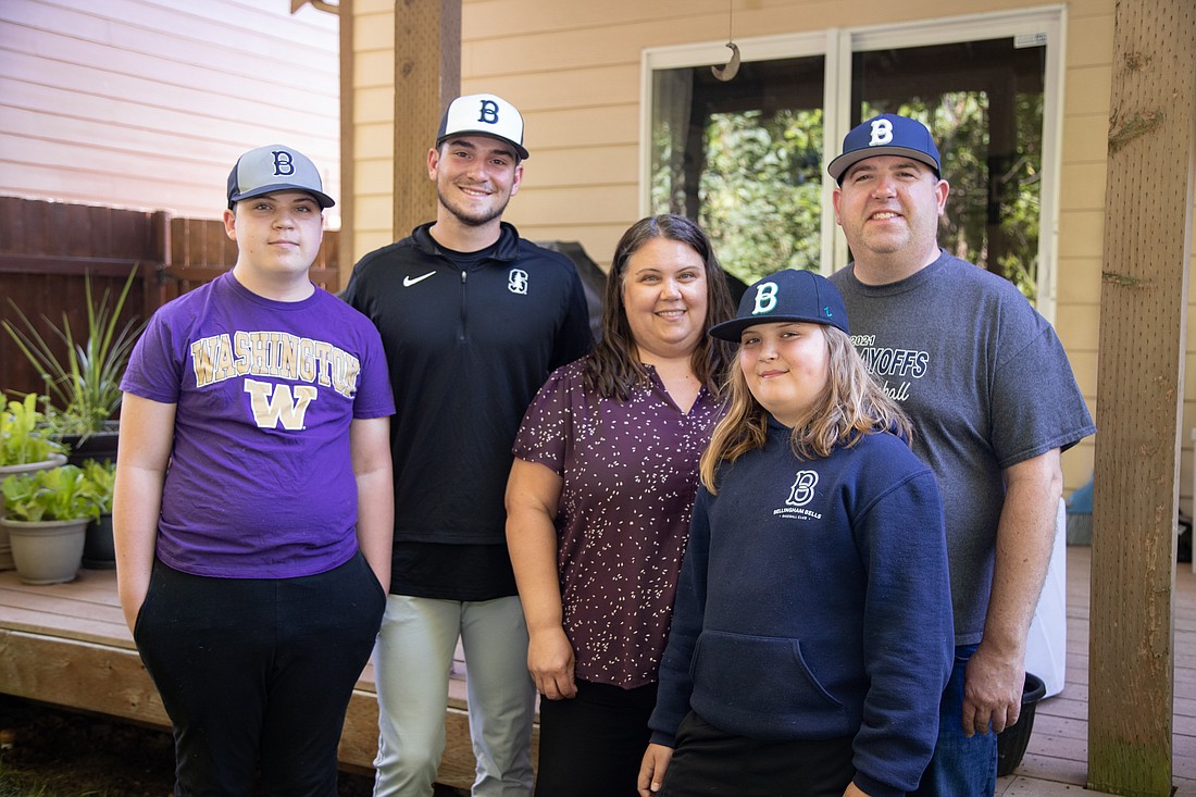 From left, Owen Swanda, Brandt Pancer, Erin Swanda, Elliot Swanda and Kevin Swanda stand in the backyard of the Swandas' home on July 18. Pancer plays baseball for the Bells and is staying with the family for the summer.