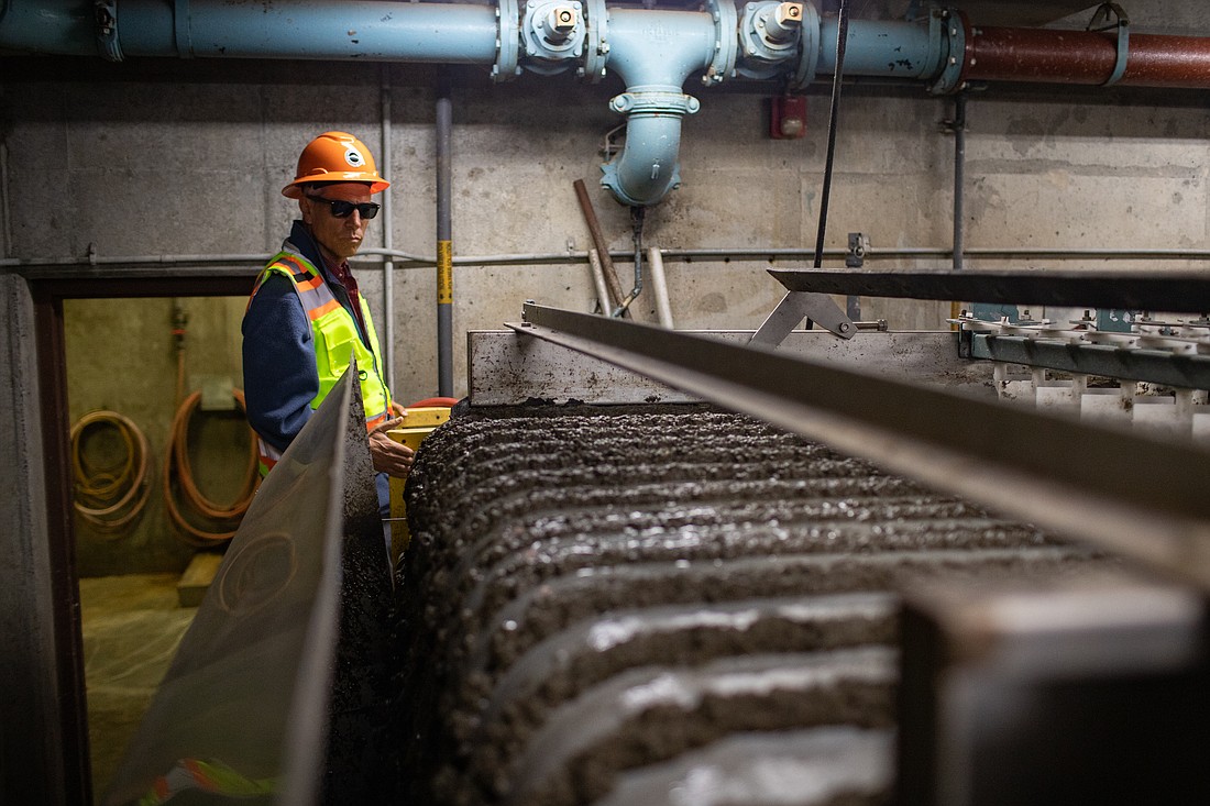 Mayor Seth Fleetwood watches a gravity belt separate liquids from sludge at the Post Point Water Treatment Plant on July 22. Fleetwood, U.S. Rep. Rick Larsen and other city officials toured the plant, which will cost more than $220 million to update and continue operations.