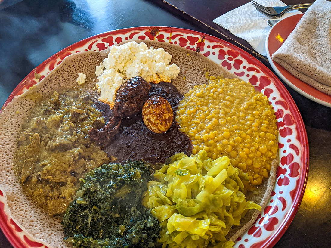 The menu at Ambo Ethiopian Cuisine is short, so there’s no reason not to try everything. On a recent visit, half orders of alicha wat (lamb stew) and doro wat (chicken stew) came on a plate to share. Split peas, cottage cheese and vegetables were also served on the platter.