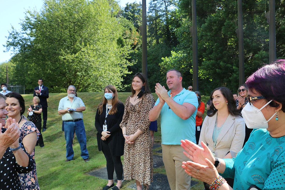 From left, Volunteers of America employees Jacy Wade, Rachel Van Duker, Michael Lane and Courtney Colwell receive a round of applause for the work they have done during the rollout of 988, a state-funded suicide hotline in Everett on July 28.