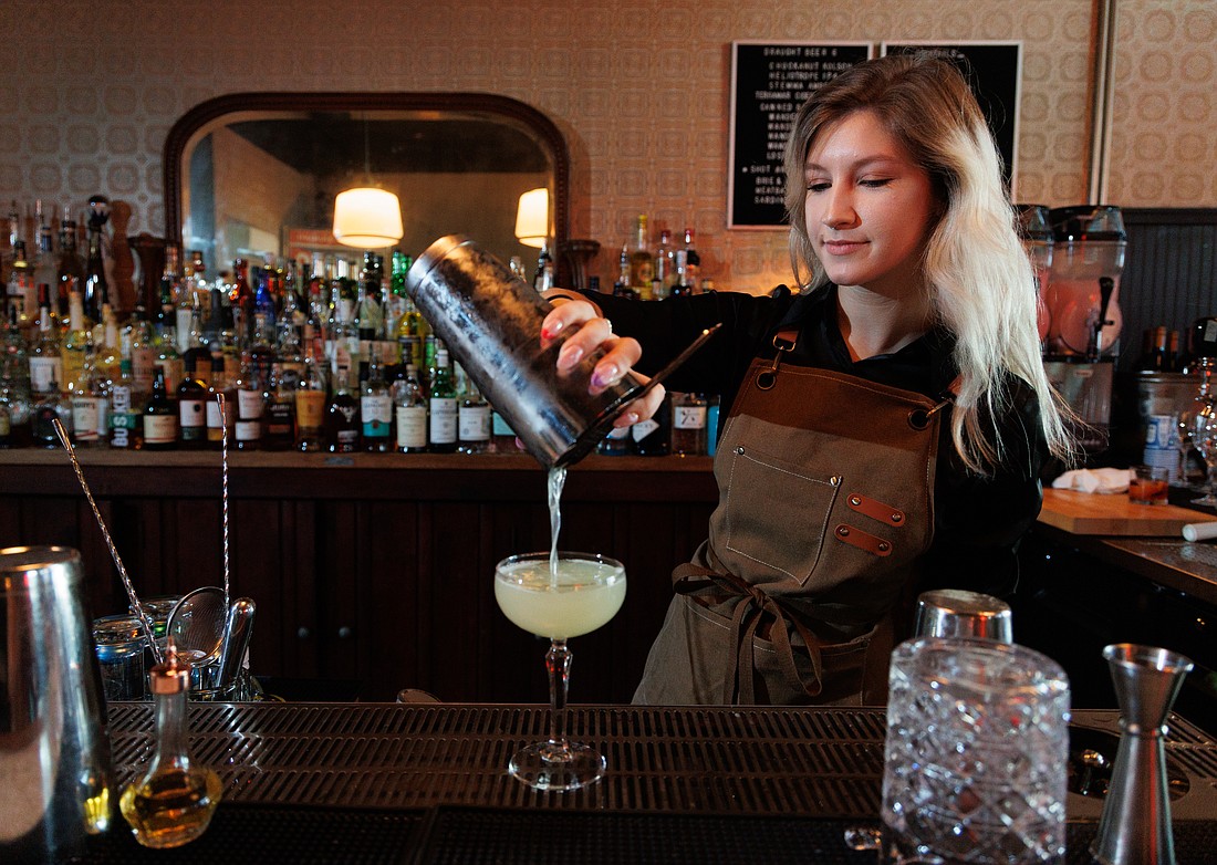 JeAnna Lombardo, a bartender at the Southside Bar, pours an Oaxaca Old Fashioned on July 29.