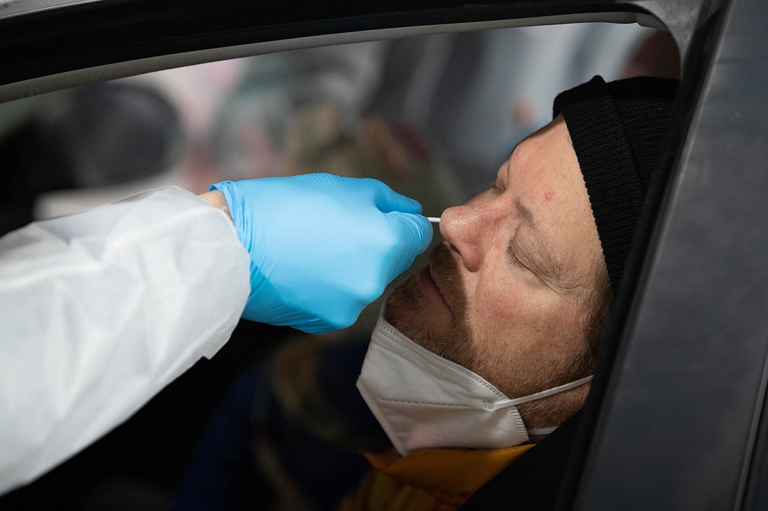 David Powers has his nose swabbed to test for COVID-19 at the Northwest Laboratory at the Bellingham International Airport test site in January.